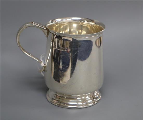 A 1970s silver christening mug and cased silver ashtray.